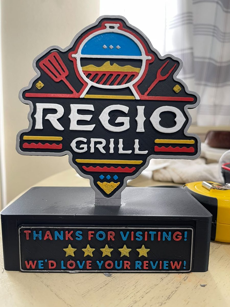 Hand-painted 3D Regio Grill review stand with the message Thanks for visiting, we'd love your review